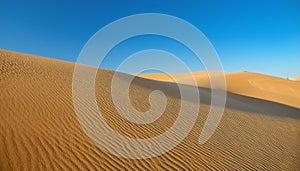 Desert concept, sand dune and blue sky