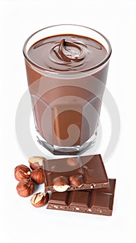 Chocolate pieces, glass of delicious paste and hazelnuts on white background