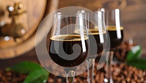 Glasses of coffee liqueur on blurred background, closeup