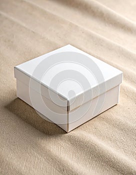 Blank White Gift Box on Textured Beige Fabric