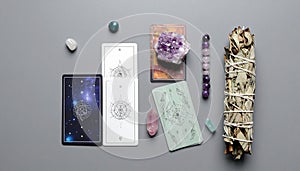 Flat Lay of Oracle Cards, Crystal Beads, and Sage Bundle on Muted Gray Background