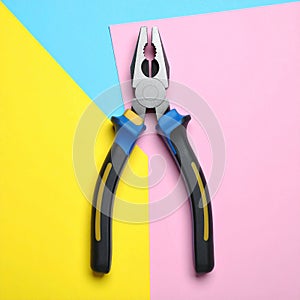 Combination pliers on color background, top view