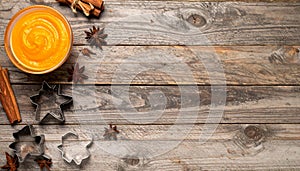 Diagonal flat lay of Halloween baking ingredients on rustic wooden table
