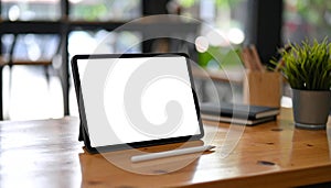 Close-Up of Tablet and Stylus on Wooden Desk