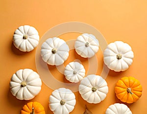 Flat lay composition with different ripe pumpkins on orange background