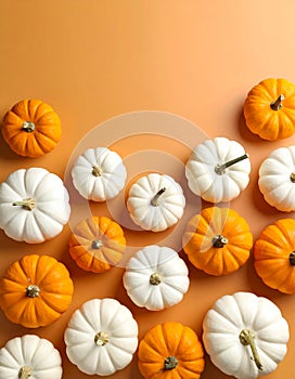 Flat lay composition with different ripe pumpkins on orange background