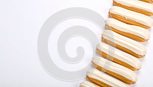 Ãclairs arranged neatly on matte soft white gradient background