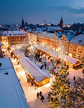 Glowing Market Stalls and Snow-Covered Rooftops