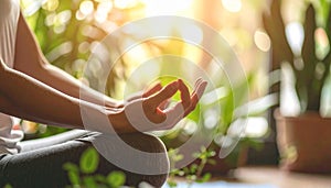 Hands resting on knees in meditation pose, cozy indoor setting