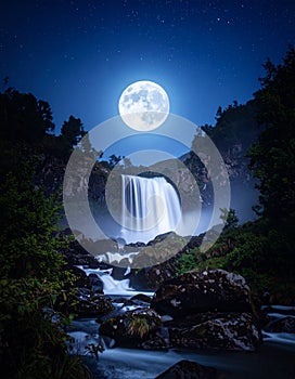 Night waterfall illuminated by moonlight