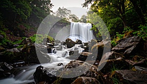 Fog drifting around waterfall and forest, mysterious mood