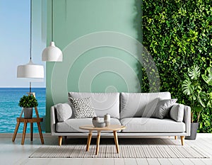 Grey sofa and nested tables near the green sea wall in the room.