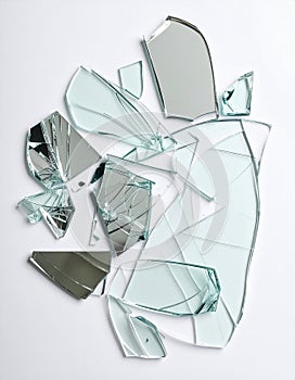Shards of broken mirror on white background, top view