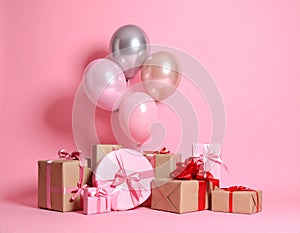 Many gift boxes and balloons near bright pink background