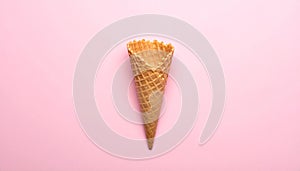 Empty wafer ice cream cone on pale pink background