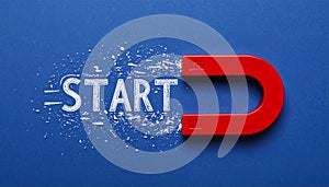 Red magnet with word START on dark blue background, top view