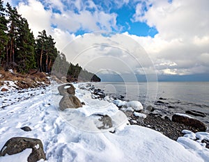 Snowy Coastline with Rocks and Sea
