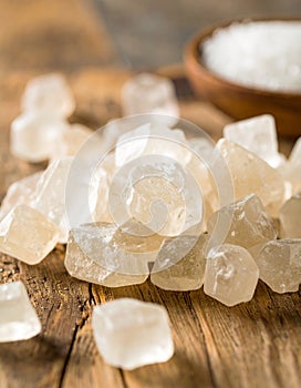 Sugar crystals are arranged on a rustic wooden surface