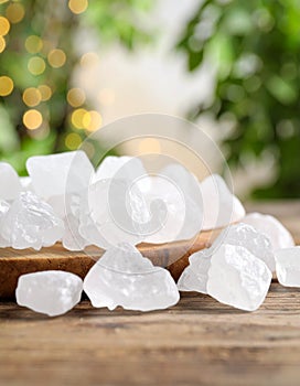 Sugar crystals are arranged on a rustic wooden surface