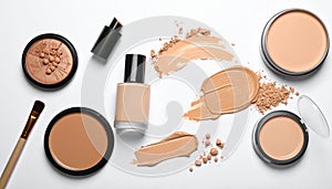 Various makeup products arranged on a white background.