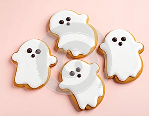 Halloween ghost cookies with icing on pastel background