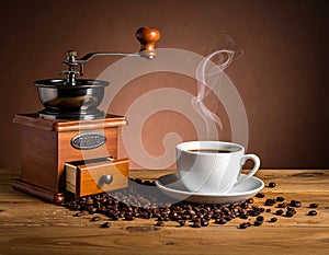 On the wooden table against the brown background, the coffee cup, beans and grinder