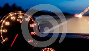 Night Driving Speedometer and Blurred Road Lights