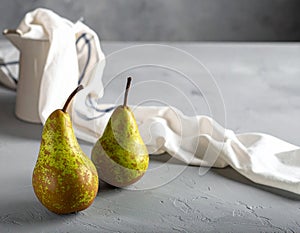 Two ripe pears on the gray table, shut up. Text area