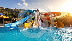 Different colorful slides in water park on sunny day