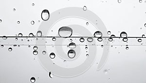 Rain drops on glass against grey background