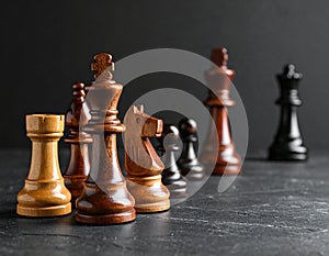 Different chess pieces on dark background. Space for text