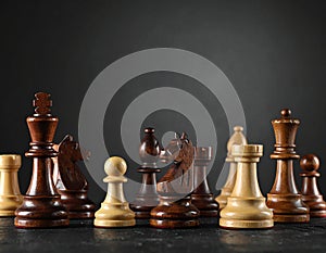 Different chess pieces on dark background. Space for text