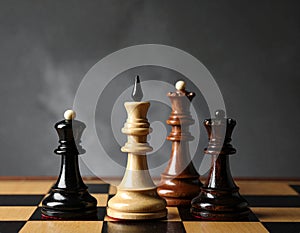 Different chess pieces on dark background. Space for text