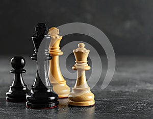 Different chess pieces on dark background. Space for text