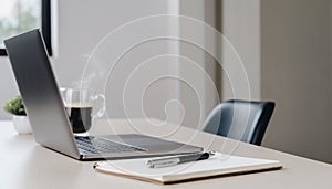 Minimalist workspace with laptop, notebook and coffee cup