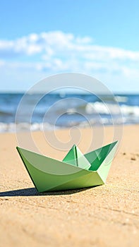 Light green paper boat near sea on sandy beach, space for text