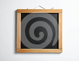 One blank small blackboard on white wall