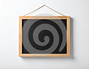 One blank small blackboard on white wall