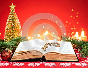Christmas red background with Bible and rosary on the table