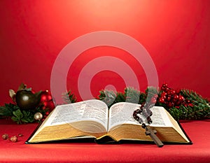 Christmas red background with Bible and rosary on the table