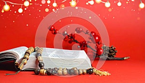 Christmas red background with Bible and rosary on the table