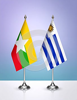 Myanmar and Uruguay flags the relationship with the table, gradient background. Vector