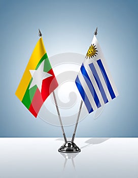 Myanmar and Uruguay flags the relationship with the table, gradient background. Vector