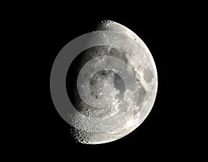 The moon over dark black sky at night