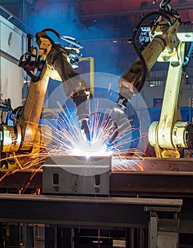 Robotic arm welding in smart factory. Industry 4.0 automation, modern manufacturing technology, and metalworking process