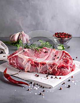 Raw meat on the kitchen table on a metallic background in a composition with cooking