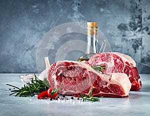 Raw meat on the kitchen table on a metallic background in a composition with cooking