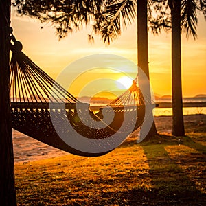 Sunset with hammock in silhouette shadow with orange light effect.