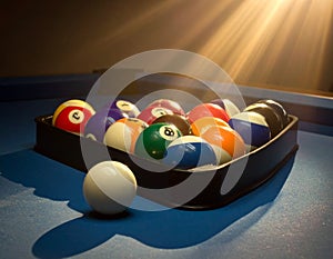 Billiard balls arranged in a triangular rack on a blue pool table