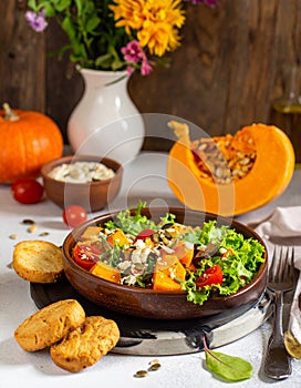 Pumpkin dish with a salad and biscuits
